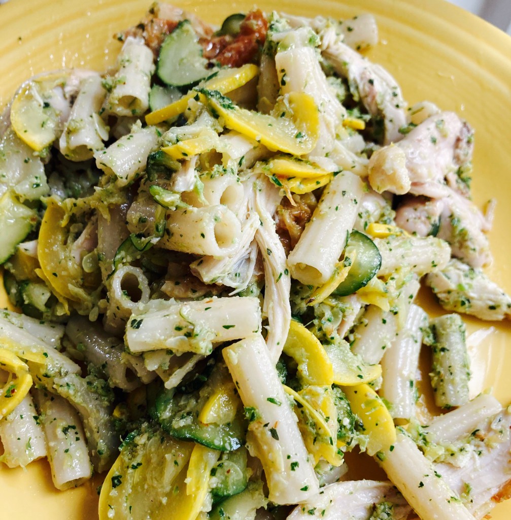 Picture of pesto mixed with pasta, veggies and chicken
